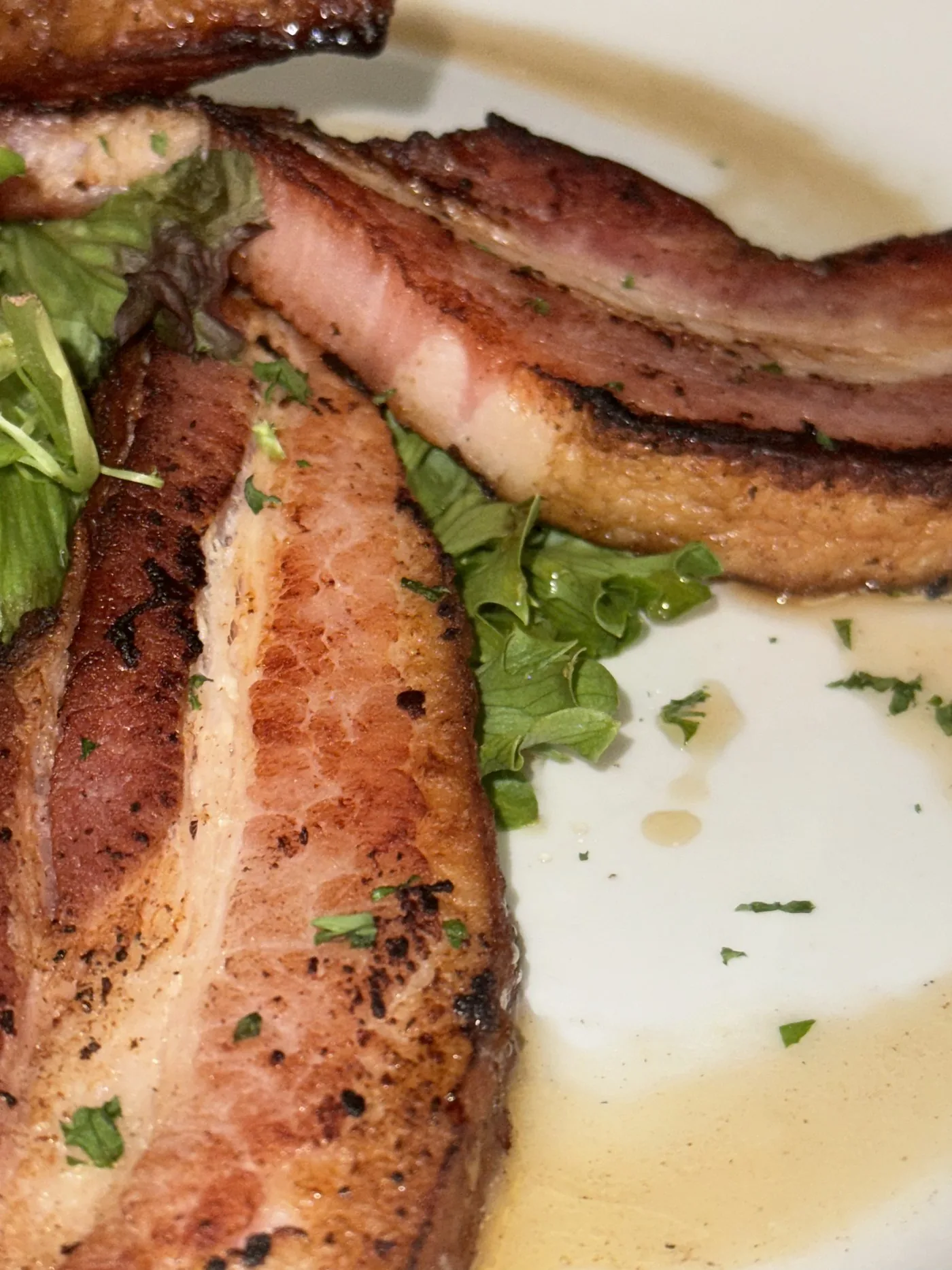 Crispy pork belly, slow rendered and flash fried, with greens