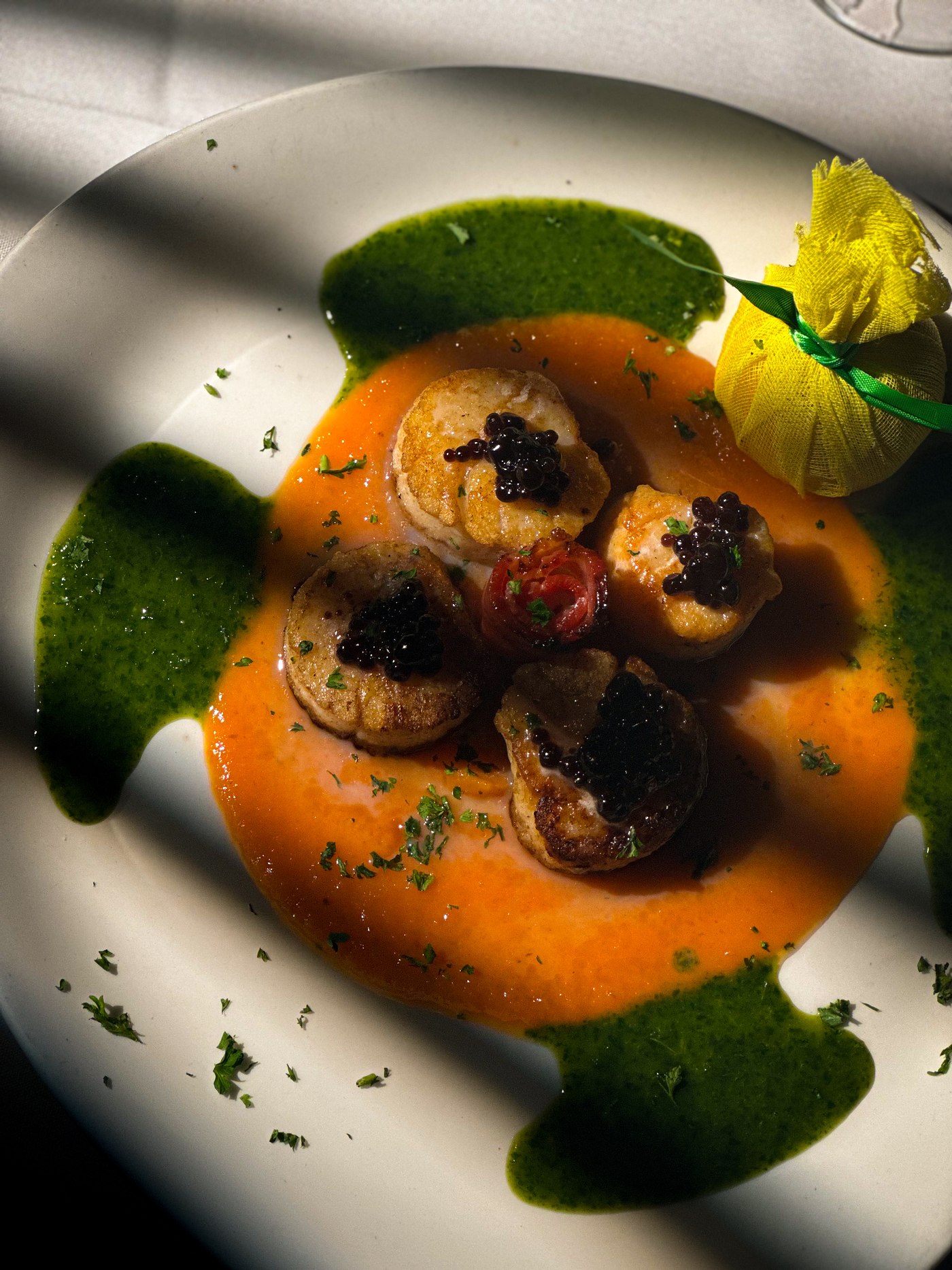 Pan seared sea scallops with pork belly and julienne vegetables