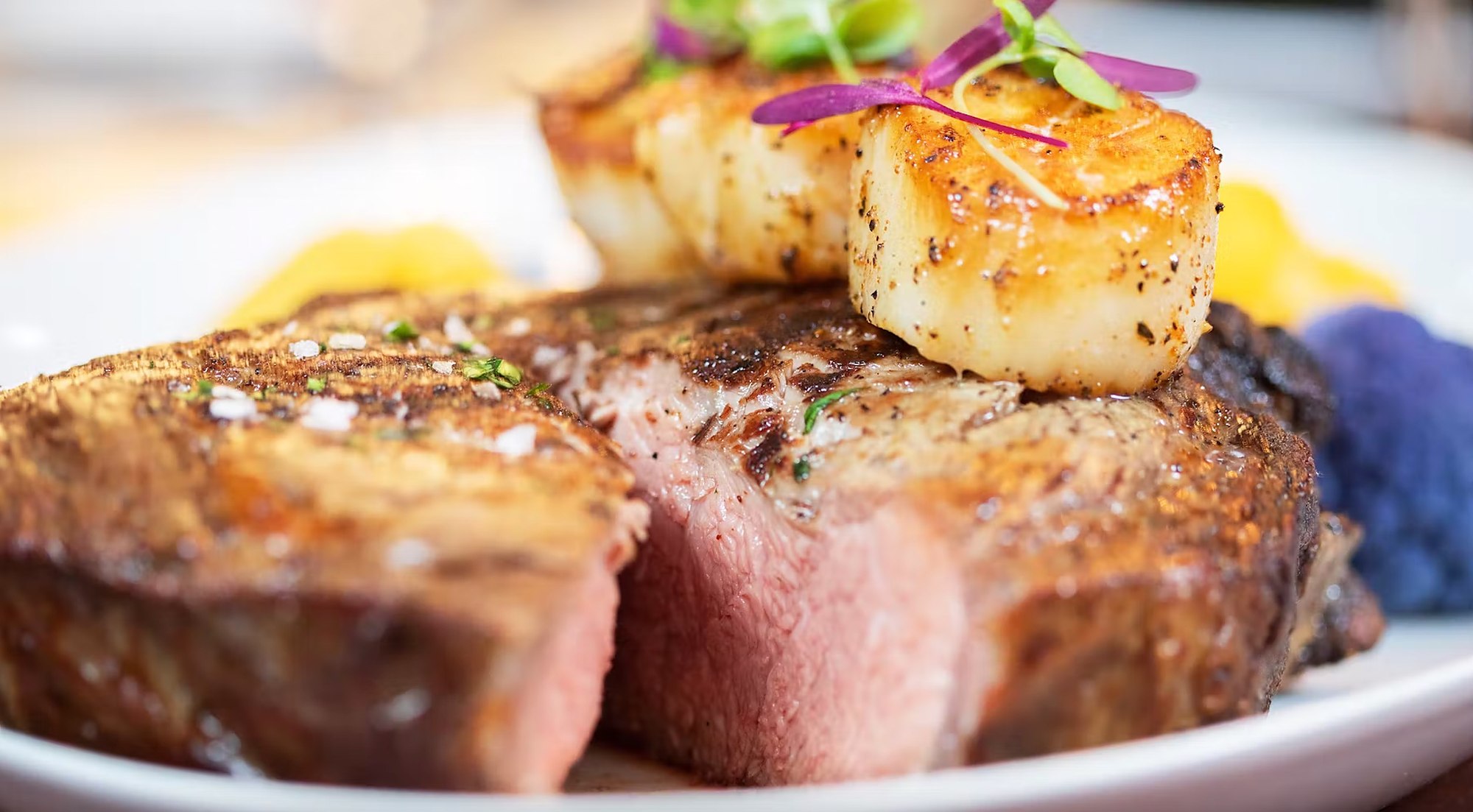 Prime steak finished with seared scallops