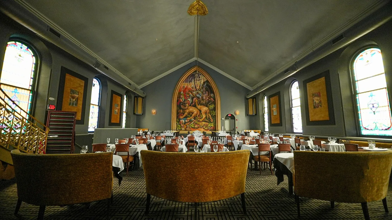 The upstairs loft with velvet banquettes, looking toward the mural