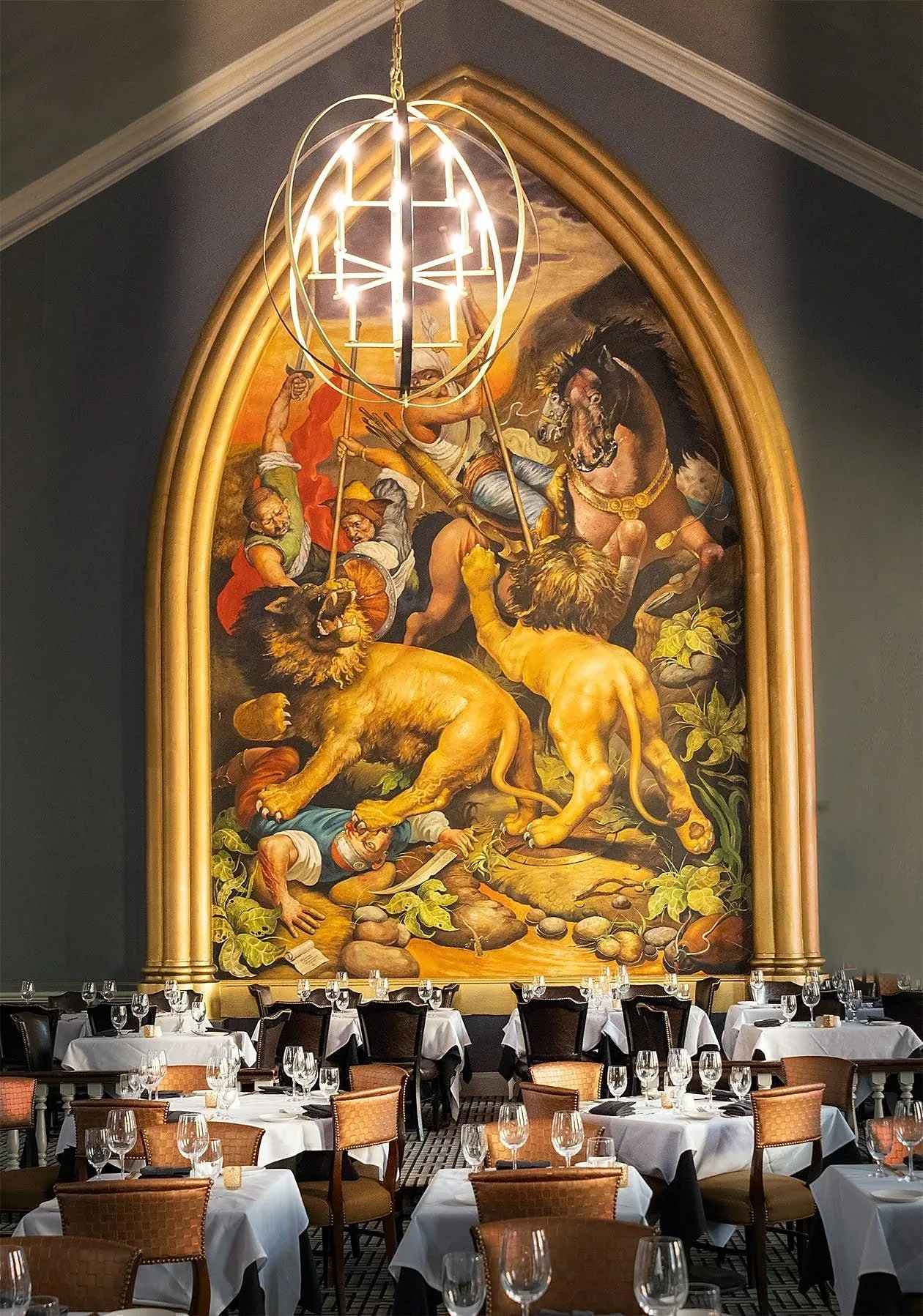 The gilded arch and mural above the dining room