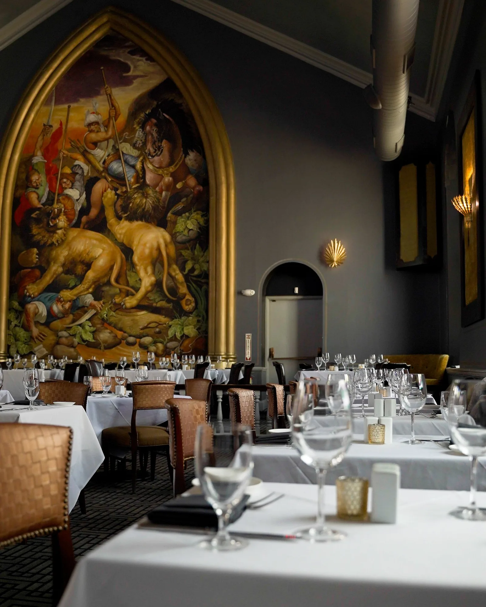 The gilded arch and the mural Redemption above the dining room